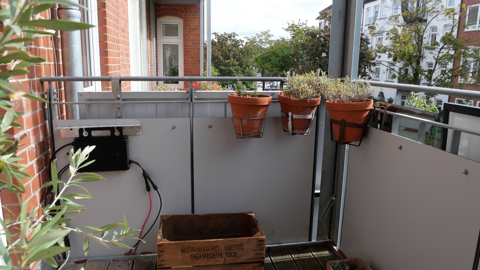 The back side of a pair of solar panels is seen from the balcony of an apartment that is using the technology to provide power.