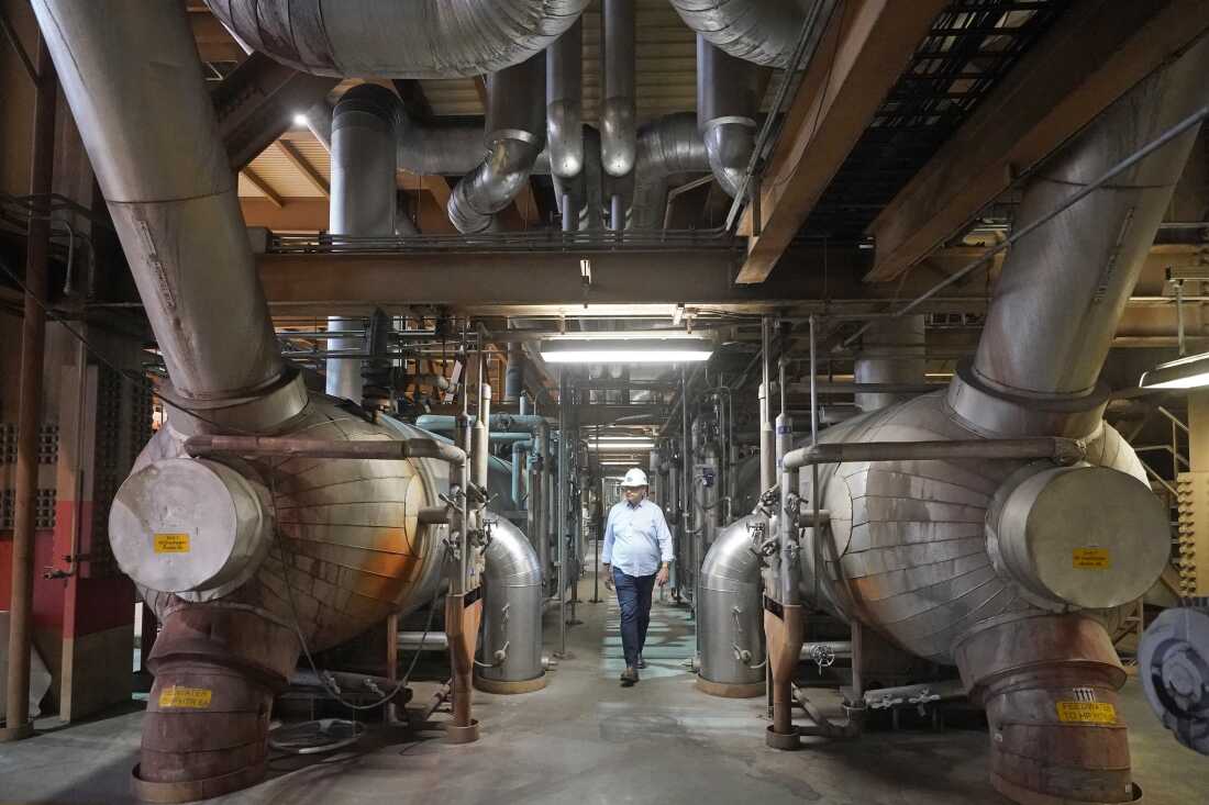 Intermountain Power Agency spokesperson John Ward walks through the coal plant near Delta, Utah, in 2022.