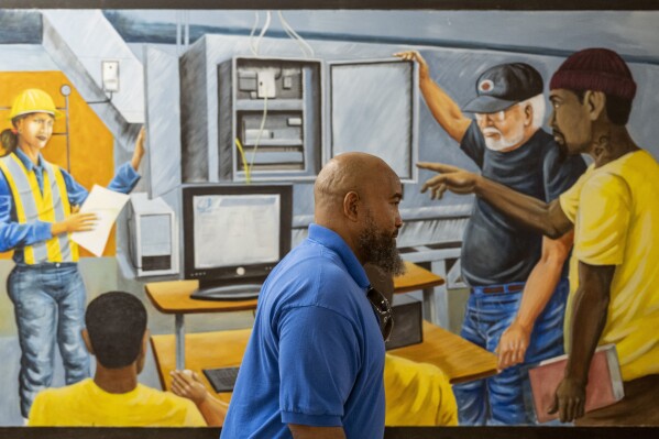 Jackie Robinson, an instructor at the Energy Coordinating Agency, a nonprofit focused in part on energy equity, teaches a class at the facility on Tuesday, July 2, 2024, in Philadelphia. (AP Photo/Joe Lamberti)