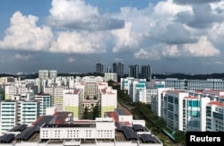 A view of public apartment blocks, with solar panels affixed to the roof of some blocks, in Singapore, June 27, 2019.