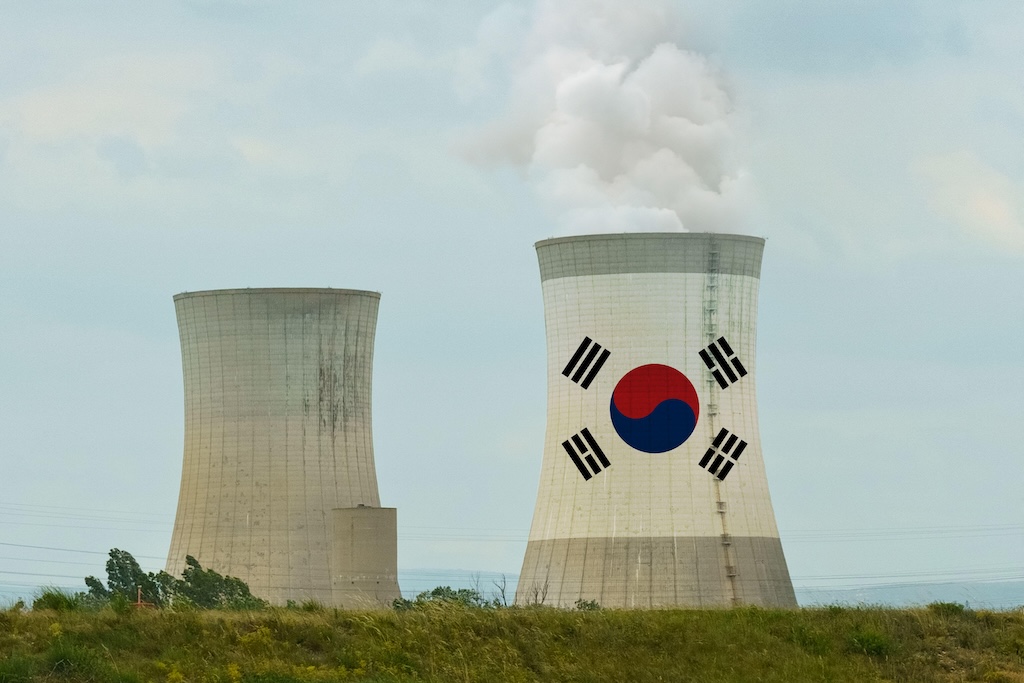 The flag of South Korea is depicted on the cooling tower of a nuclear power plant.