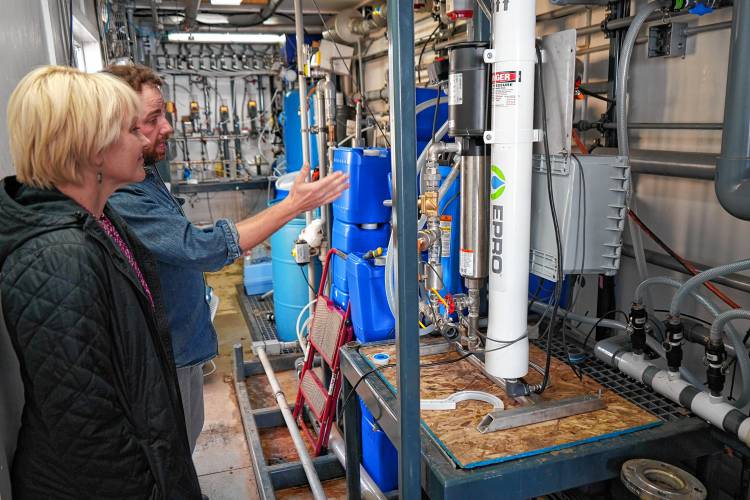 Emily Reichert, CEO of the Massachusetts Clean Energy Center, gets a tour by research engineer Patrick Wittbold of laboratory work taking place at the Water and Energy Technology Center atThursday at UMass.