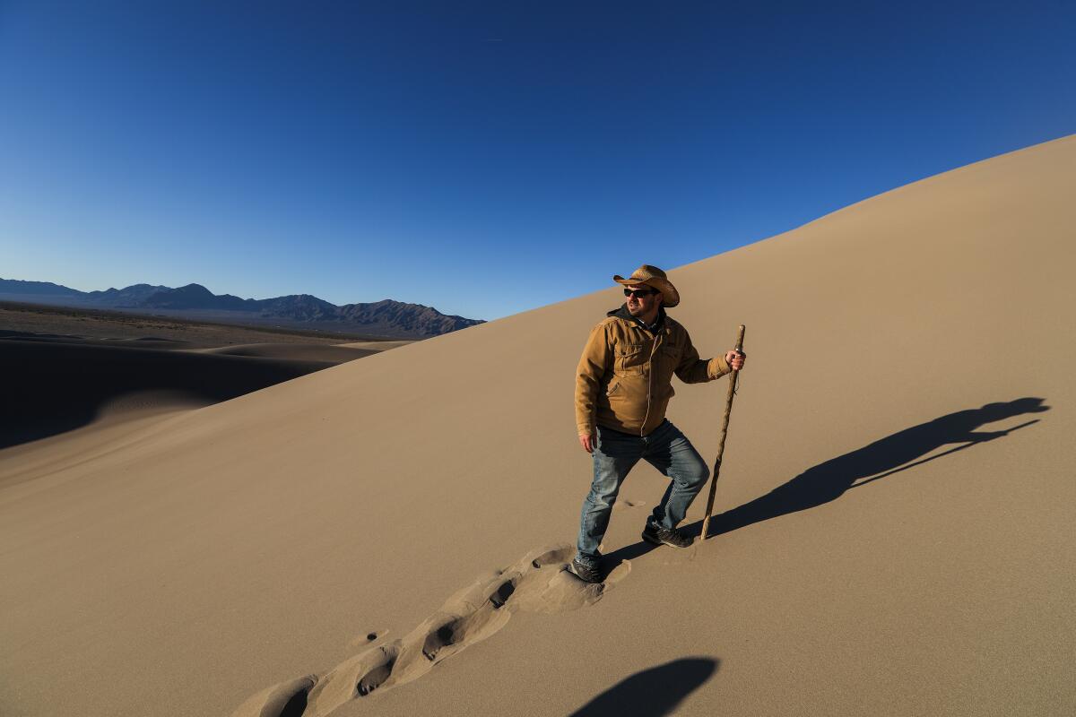 Patrick Donnelly of the Center for Biological Diversity hikes up Big Dune, 90 miles northwest of Las Vegas, in 2023.