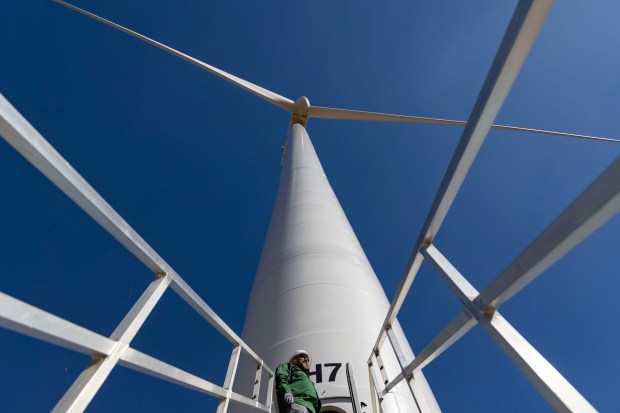 Jon Lilley, plant manager at Midland Wind Farm in Henry County, stands below a working turbine, Oct. 2, 2024, in Kewanee. (Brian Cassella/Chicago Tribune)