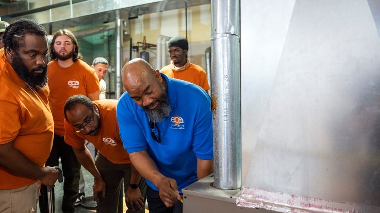 Jackie Robinson, an instructor at the Energy Coordinating Agency, a...