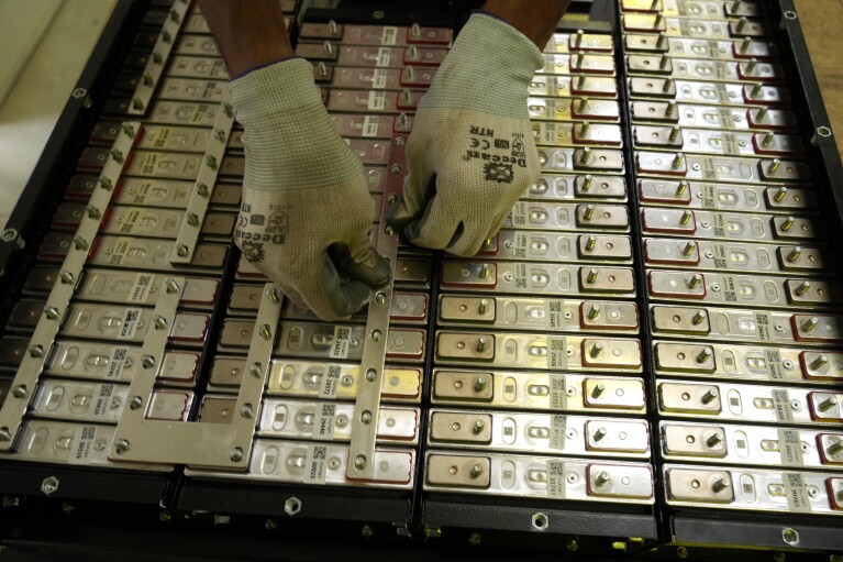 A battery production engineer at Nunam assembles a refurbished battery pack, made from used electric vehicle batteries, at their facility in Bengaluru, India, Tuesday, Oct. 8, 2024. (AP Photo/Aijaz Rahi)