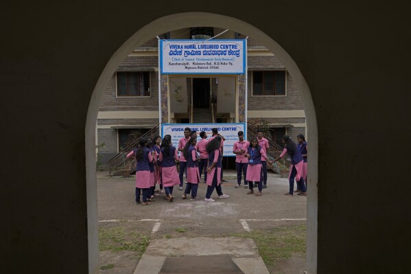 Students enrolled for professional training courses interact during a break, at the campus of the Swami Vivekananda Youth Movement, a nongovernmental organization that works to help poor and Indigenous communities, in Kenchanahalli, India, Monday, Sept. 23, 2024. (AP Photo/Aijaz Rahi)