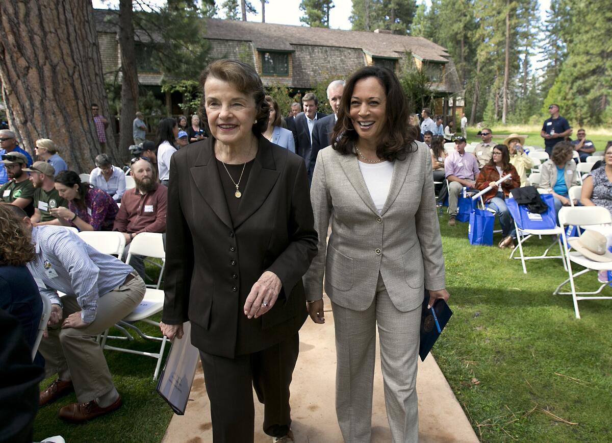 Then-Sens. Dianne Feinstein and Kamala Harris walk together at a 2017 summit at Lake Tahoe.