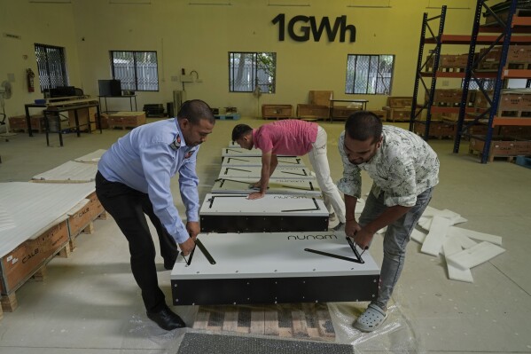 Employees of Nunam pack refurbished battery packs, made from used electric vehicle batteries, before shipping to their clients, at their facility in Bengaluru, India, Tuesday, Oct. 8, 2024. (AP Photo/Aijaz Rahi)